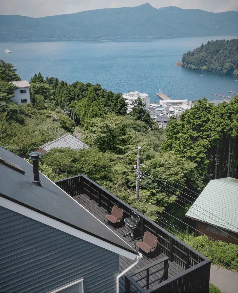 Lake Ashi, the red torii gate of Hakone Shrine, and the town of Motohakone seen over the villa's wood deck